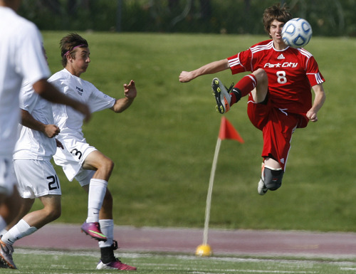Scott Sommerdorf   |  The Salt Lake Tribune
Park City's Sully Tesch makes a play on the ball as Desert Hills' Spencer Rhoton, #3, left, chases. Park City defeated Desert Hills 2-1 in the 3A boys' soccer state semifinal, Friday, May 10, 2013. They advance to tomorrow's 3A final.