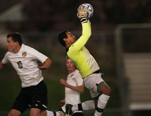 Scott Sommerdorf   |  The Salt Lake Tribune
Ogden goalkeeper Auggue Garcia makes a save with Wasatch's Ben Powell close by late in the second half. Wasatch beat Ogden 2-1 in OT in the 3A boys' soccer state semifinal at the half, Friday, May 10, 2013.