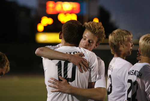Scott Sommerdorf   |  The Salt Lake Tribune
Team mates hug Ben Powell after he scored the winning gol in OT. Wasatch beat Ogden 2-1 in OT in the 3A boys' soccer state semifinal at the half, Friday, May 10, 2013.