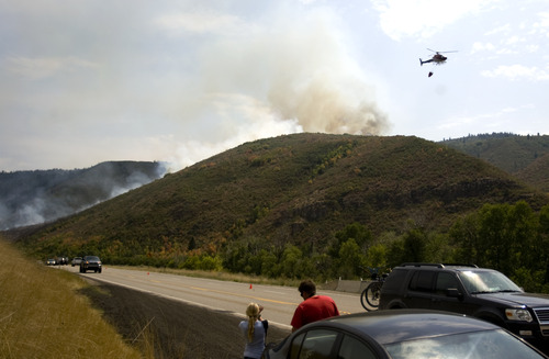 Kim Raff | The Salt Lake Tribune
People watch as firefighters battle a new wildfire off Highway 40 outside of Heber in Wasatch County,Utah on August 19, 2012.