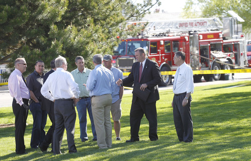 Al Hartmann  |  The Salt Lake Tribune
Church leaders and neighbors survey damage as Unified Fire Authority responds to a fire at an LDS Church building at 7525 W. 3735 South on Monday morning May 13.
