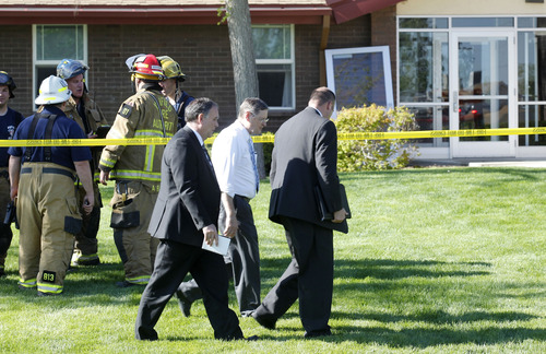 Al Hartmann  |  The Salt Lake Tribune
Church leaders survey damage as the Unified Fire Authority responds to a fire at an LDS Church building at 7525 W. 3735 South on Monday morning May 13.