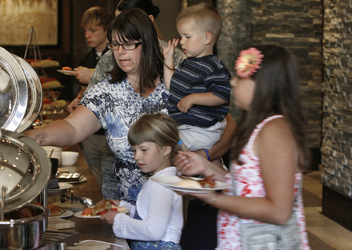 Scott Sommerdorf   |  The Salt Lake Tribune
Stephanie Humiston holds her son Caleb, 2, as daughters Victoria, 6, and Katelyn, 9, right, go through the buffet line at the Mother's Day Brunch given for Hill Air Force families at the St. Regis Deer Valley in Park City, Sunday, May 12, 2013. Her husband, Lt. Col. Darin Humiston, is deployed.