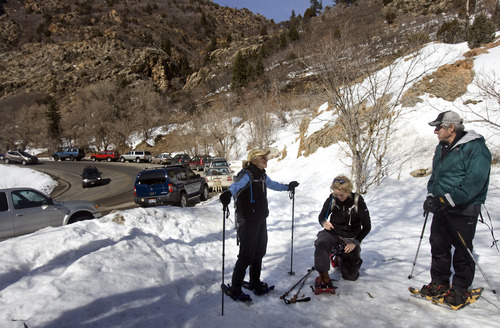 Kim Raff  |  The Salt Lake Tribune
With parked cars filling the S-Curve in the background, snowshoers Kathy Crismon, Jenni Jeremy and Tom Crismon (from left) get ready to head out from the Mill B South trailhead in Big Cottonwood Canyon on March 2, 2013. Salt Lake County studied parking in Big Cottonwood and Little Cottonwood canyons. The study recommends 17 areas where changes should be made.
