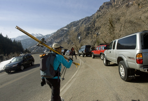 Kim Raff  |  The Salt Lake Tribune
Abbi Fisher carries skies to a car parked on the S-Curve at the Mill B South trailhead in Big Cottonwood Canyon on March 2, 2013. Improving pedestrian safety is one goal of a parking study that Salt Lake County oversaw in Big Cottonwood and Little Cottonwood canyons. The study recommends 17 areas where changes should be made, including prohibiting parking along the road outside of this trailhead.