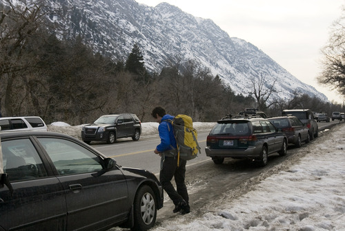 Kim Raff  |  The Salt Lake Tribune
A man walks to his car parked in the climbing area of lower Little Cottonwood Canyon on March 2, 2013. Salt Lake County studied parking in Big Cottonwood and Little Cottonwood canyons. The study recommends 17 areas where changes should be made, including prohibiting parking along the road outside of this trailhead.