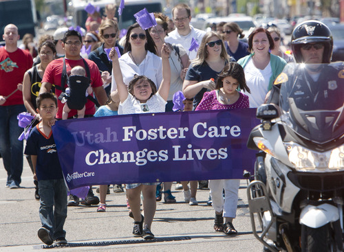 Steve Griffin  |  The Salt Lake Tribune
Foster kids march with police officers and firefighters to celebrate National Foster Care Month in Salt Lake City Friday May 10, 2013.
