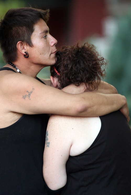 Kim Raff | The Salt Lake Tribune
A woman is comforted as police investigate a fatal shooting on Grant Street in Salt Lake City, Utah on July 28, 2012.