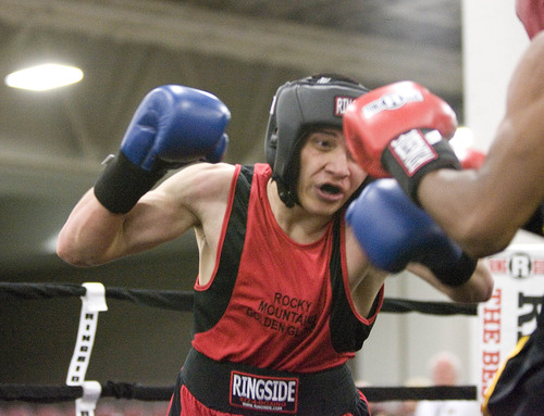 Paul Fraughton  |   Salt Lake Tribune
  Salt Lake's Daniel Galloway, wearing blue gloves,  fights   Carlos Monroe of Florida in a 165 lb. weight class. Monroe won the fight.                        
 Monday, May 13, 2013