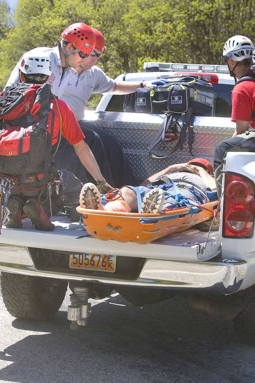 Paul Fraughton  |  The Salt Lake Tribune
A  Weber County Search and Rescue team rides in the back of a pickup truck with a man they just rescued from a cliff near the summit of the North Ogden Pass road.                       
 Tuesday, May 14, 2013