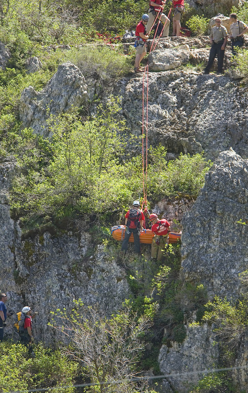 Paul Fraughton  |  The Salt Lake Tribune
A  Weber County Search and Rescue Team lowers a man with an injured leg down a cliff near the summit of the North Ogden Pass road on Tuesday, May 14, 2013.