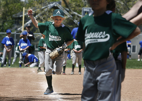 Scott Sommerdorf   |  The Salt Lake Tribune
Homer Riva-Cambrin, 8, excitedly runs onto the field as he and his "Alligators" team is introduced. The Avenues Baseball League kicked off its season on Saturday.