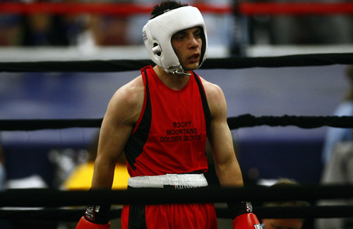 Chris Detrick  |  The Salt Lake Tribune
West Valley City's Isaac Aguliar, in red, fights Ja'Rico O'Quinn, of Detroit, in the 123 lb boxing match during the National Golden Gloves Boxing tournament at the Calvin L. Rampton Salt Palace Convention Center Thursday May 16, 2013. O'Quinn won the match.