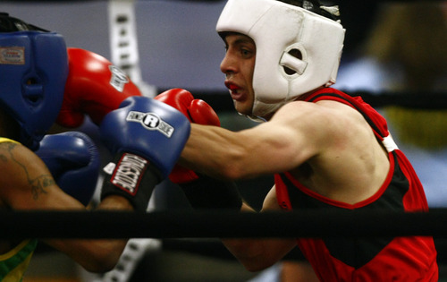 Chris Detrick  |  The Salt Lake Tribune
West Valley City's Isaac Aguliar, in red, fights Ja'Rico O'Quinn, of Detroit, in the 123 lb boxing match during the National Golden Gloves Boxing tournament at the Calvin L. Rampton Salt Palace Convention Center Thursday May 16, 2013. O'Quinn won the match.