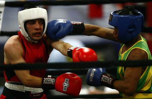 Chris Detrick  |  The Salt Lake Tribune
West Valley City's Isaac Aguliar, in red, fights Ja'Rico O'Quinn, of Detroit, in the 123 lb boxing match during the National Golden Gloves Boxing tournament at the Calvin L. Rampton Salt Palace Convention Center Thursday May 16, 2013. O'Quinn won the match.