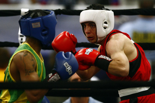 Chris Detrick  |  The Salt Lake Tribune
West Valley City's Isaac Aguliar, in red, fights Ja'Rico O'Quinn, of Detroit, in the 123 lb boxing match during the National Golden Gloves Boxing tournament at the Calvin L. Rampton Salt Palace Convention Center Thursday May 16, 2013. O'Quinn won the match.