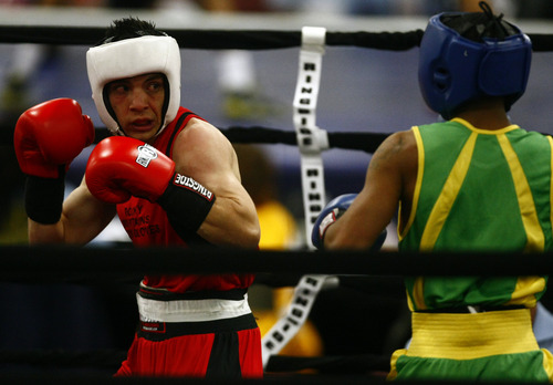 Chris Detrick  |  The Salt Lake Tribune
West Valley City's Isaac Aguliar, in red, fights Ja'Rico O'Quinn, of Detroit, in the 123 lb boxing match during the National Golden Gloves Boxing tournament at the Calvin L. Rampton Salt Palace Convention Center Thursday May 16, 2013. O'Quinn won the match.