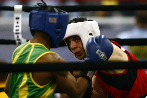 Chris Detrick  |  The Salt Lake Tribune
West Valley City's Isaac Aguliar, in red, fights Ja'Rico O'Quinn, of Detroit, in the 123 lb boxing match during the National Golden Gloves Boxing tournament at the Calvin L. Rampton Salt Palace Convention Center Thursday May 16, 2013. O'Quinn won the match.