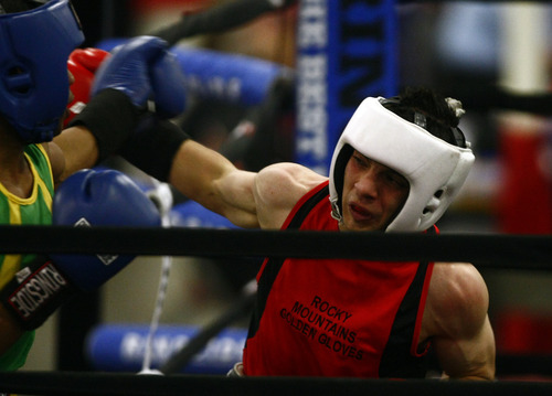 Chris Detrick  |  The Salt Lake Tribune
West Valley City's Isaac Aguliar, in red, fights Ja'Rico O'Quinn, of Detroit, in the 123 lb boxing match during the National Golden Gloves Boxing tournament at the Calvin L. Rampton Salt Palace Convention Center Thursday May 16, 2013. O'Quinn won the match.