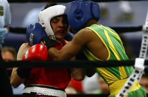 Chris Detrick  |  The Salt Lake Tribune
West Valley City's Isaac Aguliar, in red, fights Ja'Rico O'Quinn, of Detroit, in the 123 lb boxing match during the National Golden Gloves Boxing tournament at the Calvin L. Rampton Salt Palace Convention Center Thursday May 16, 2013. O'Quinn won the match.