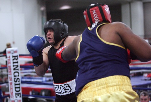 Kim Raff  |  The Salt Lake Tribune
Texas boxer (left) Kent Brinson punches (right) Jermaine Franklin, from Michigan, during the 201+  weight class semifinal match of the 2013 Golden Gloves National Tournament in Salt Lake City on May 17, 2013. Franklin went on to win the match by decision.