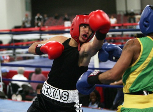 Kim Raff  |  The Salt Lake Tribune
Texas boxer (left) Francisco Martinez punches (right) Ja'Rico O'Quinn, from Detroit, during the 123 lb. weight class semifinal match of the 2013 Golden Gloves National Tournament in Salt Lake City on May 17, 2013. Martinez went on to lose the match by decision to O'Quinn.