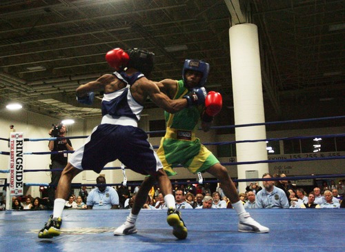 Kim Raff  |  The Salt Lake Tribune
(left) Gary Antonia Russell, of Washington DC, is a punched by (right) Ja'Rico O'Quinn, of Detroit, during the championship 123 lb. weight class match at Golden Gloves National Championship at the Salt Palace Convention Center in Salt Lake City on May 18, 2013. Russell went on to win the championship.