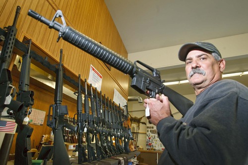 Paul Fraughton  |  Tribune file photo
Frank Baer, the owner of Patriot Arms and Gun Repair in West Jordan holds a Bushmaster AR15 223cal Rifle at his gun shop. The election years of 2008 set an all-time record for gun sales in Utah, topped by the election-year of 2012. Last December saw a huge spike in firearms purchases and sales have stayed well above-average ever since, according to state records.