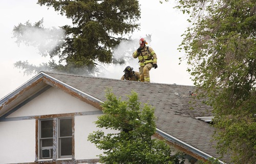 Leah Hogsten  |  The Salt Lake Tribune
Five Salt Lake City fire crews work to put out at fire in the 400 block of 1200 East. A dog's incessant barking alerted its owner to a fire in the second floor of their rental home, Friday, May 17, 2013. Three people who were home at the time were able to get out of the burning house unharmed.