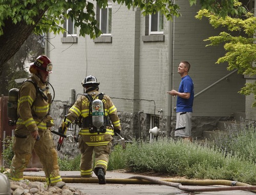 Leah Hogsten  |  The Salt Lake Tribune
Homeowner Dave King watches as  Salt Lake City fire crews work to put out at fire  at his rental home in the 400 block of 1200 East. A dog's incessant barking alerted its owner to a fire in the second floor of their rental home, Friday, May 17, 2013. Three people who were home at the time were able to get out of the burning house unharmed.