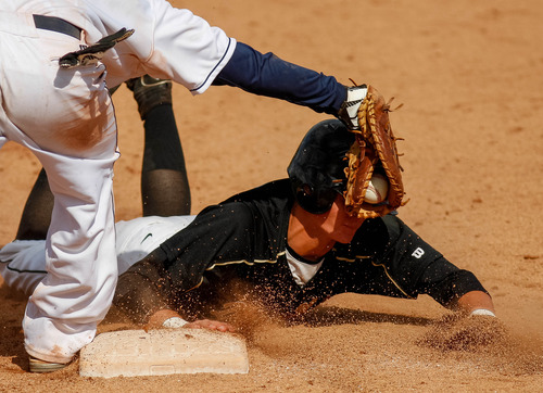 Trent Nelson  |  The Salt Lake Tribune
Desert Hills' Ty Rutlede dives safely back to first despite the tag by Snow Canyon's Riley Gates. Snow Canyon defeated Desert Hills High School for the 3A boys baseball state championship in Orem Saturday May 18, 2013.