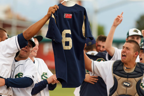 Trent Nelson  |  The Salt Lake Tribune
Snow Canyon players honored their fallen teammate Kreg "K.J." Harrison, who drowned last year, by holding his jersey aloft following their championship win. Snow Canyon defeated Desert Hills High School for the 3A boys baseball state championship in Orem Saturday May 18, 2013.
