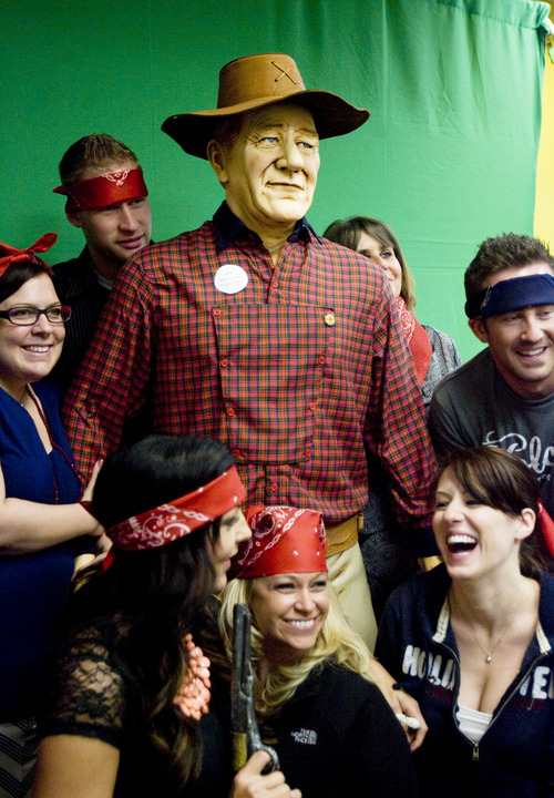 Kim Raff  |  The Salt Lake Tribune
Employees pose around a statue of John Wayne for a photo booth photograph that was one of the activities during the CHG Heathcare Services employee appreciation barbecue for the company's 844 employees at its offices in Cottonwood Heights on Monday, May 20, 2013. The barbecue is part of the company's 10th annual Employee Appreciation Week that is happening in all seven of its offices around the country. CHG Heathcare Services is ranked 3rd in best companies to work for among Fortune 500 companies.