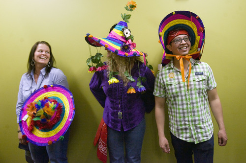 Kim Raff  |  The Salt Lake Tribune
Employees (from left) Angela Brown, Allie Motzkus and Miguel Martinez wear hats for a photo booth during the CHG Heathcare Services employee appreciation barbecue for the company's 844 employees at its offices in Cottonwood Heights on Monday, May 20, 2013. The barbecue is part of the company's 10th annual Employee Appreciation Week that is happening in all seven of its offices around the country. CHG Heathcare Services is ranked 3rd in best companies to work for among Fortune 500 companies.