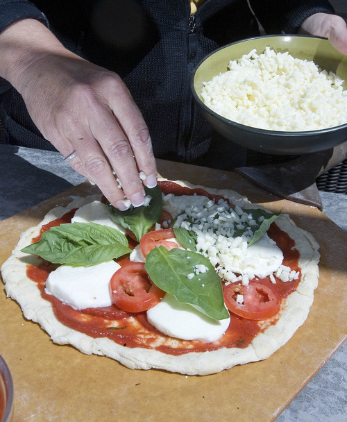 Paul Fraughton  |  The Salt Lake Tribune
Sue Measom prepares a pizza to be cooked outdoors in the Camp Chef pizza oven.