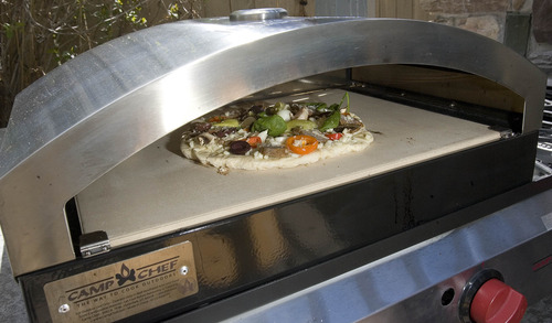 Paul Fraughton  |  The Salt Lake Tribune
A pizza cooks in Camp Chef's new pizza oven.