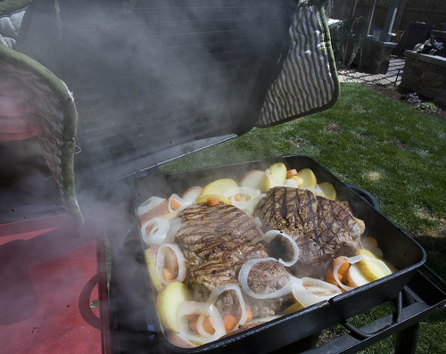 Paul Fraughton  |  The Salt Lake Tribune
The lid comes off Camp Chef's square Dutch oven to reveal a beef roast cooked with vegetables.