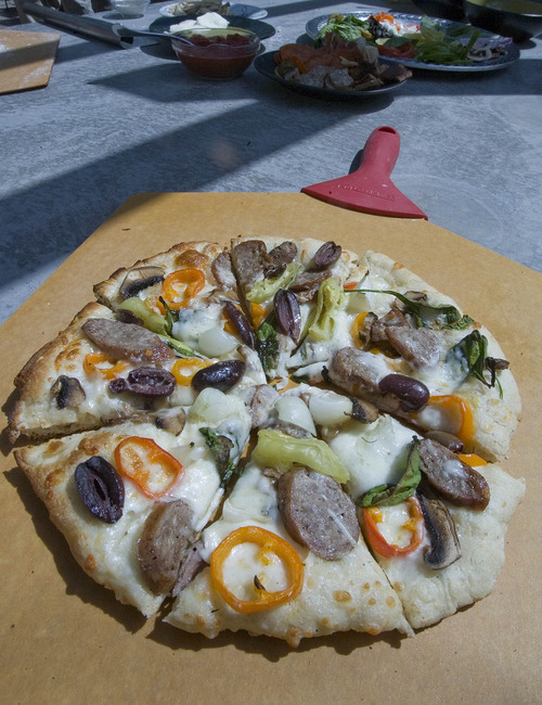 Paul Fraughton  |  The Salt Lake Tribune
A pizza cooked in Camp Chef's new pizza oven.