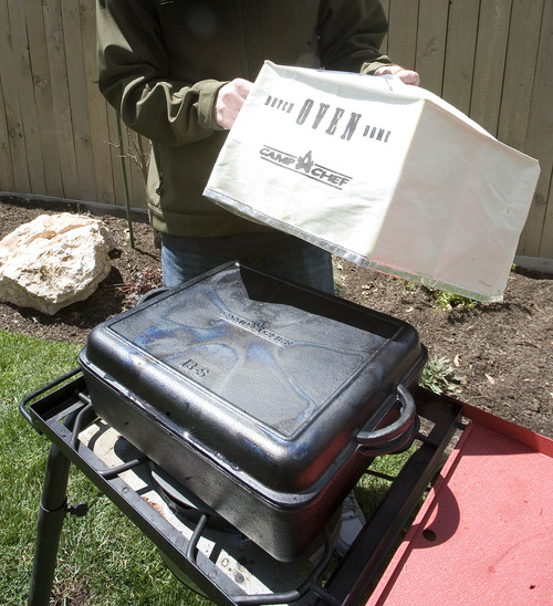 Paul Fraughton  |  The Salt Lake Tribune
A Dutch oven dome is placed over the square pot to circulate the heat evenly.