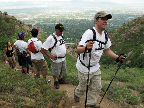 Francisco Kjolseth  |  The Salt Lake Tribune    
Salt Lake City - Paul Cardall, followed by his father Duane and friends and family makes his way up Mount Olympus on Wed. June 9, 2010. Cardall, who had a heart transplant in September, climbed Mount Olympus on the 1-year-anniversary of his brother's death. Brian Cardall was killed after police Tasered him during a traffic stop.