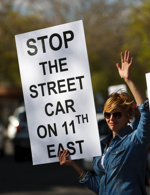 Trent Nelson  |  The Salt Lake Tribune
Brenda Nibley, waving to passing cars, was among opponents to the 1100 East extension of the Sugar House Streetcar protesting Wednesday, May 1, 2013 in Salt Lake City. Six days later the city council voted 4-3 for the 1100 East alignment.