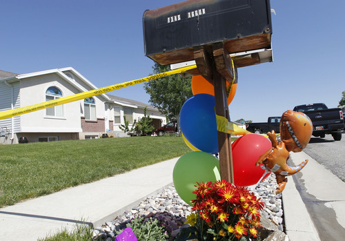 Al Hartmann  |  The Salt Lake Tribune
A shrine of balloons and flowers are placed outside a house at 120 S. 1660 West in West Point on Thursday May 23 for two children, a 4-year-old and 10-year-old who were allegedly stabbed and killed by their 15-year-old brother.