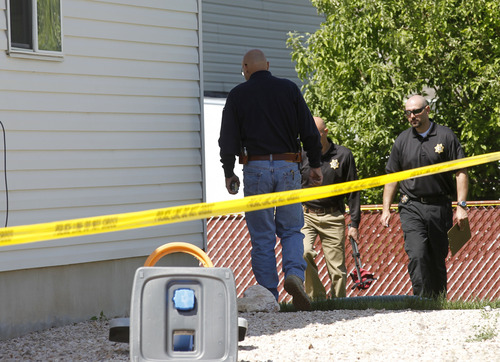 Al Hartmann  |  The Salt Lake Tribune
Davis County sheriff crime scene investigators look through the yard at 120 S. 1660 West in West Point on Thursday May 23. Two brothers, 4 and 10, were allegedly stabbed to death by their 15-year-old brother, who is now in custody.