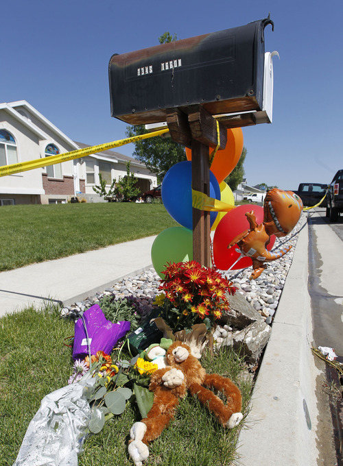Al Hartmann  |  The Salt Lake Tribune
A shrine of balloons and flowers is placed outside a house at 120 S. 1660 West in West Point on Thursday, May 23 for two brothers, 4 and 10, who were allegedly stabbed and killed by their 15-year-old brother.