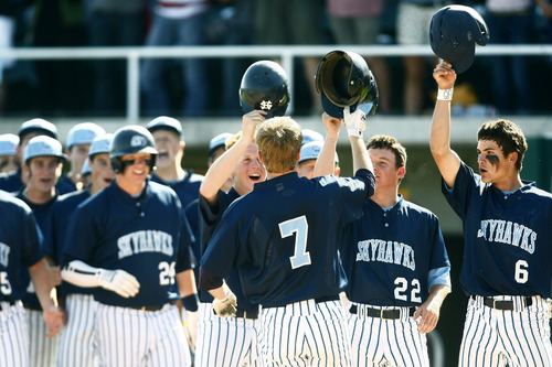 Chris Detrick  |  The Salt Lake Tribune
Members of the Salem Hills baseball team celebrates with teammate Colton Hill (7) after he hit a grand slam home run in the top of the second inning during the game at Brent Brown Ballpark at Utah Valley University Thursday May 23, 2013. Salem Hills defeated Maple Mountain 7-2.