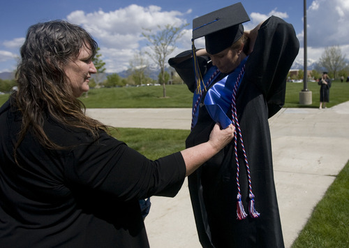 Kim Raff  |  The Salt Lake Tribune
(left) Darlene Head, Director of Veteran Services for SLCC, helps Amber Beckstead, SLCC graduate and Army veteran, get ready for the Salt Lake Community College Commencement Program outside the Maverik Center in West Valley City on May 9, 2013.