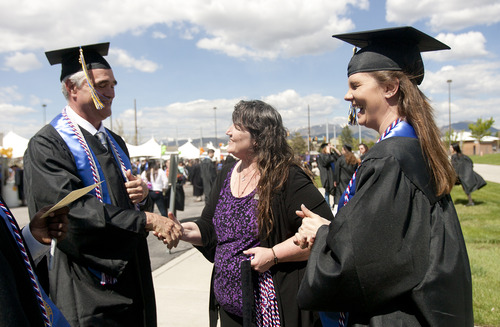 Kim Raff  |  The Salt Lake Tribune
Darlene Head, center, Director of Veteran Services at Salt Lake Community College, shakes hands with Joseph Denton, a Navy veteran who is graduating in criminal justice, as they wait outside the Maverik Center with fellow graduate, and Army veteran, Amber Beckstead before the start of SLCC's commencement in West Valley City on May 9, 2013.
