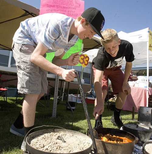 Paul Fraughton  |  The Salt Lake Tribune
Shea Rockwell and Jay Willahan check on their barbecue boneless pork ribs at Riverview Jr. High School's ninth-grade Dutch oven cook-off.