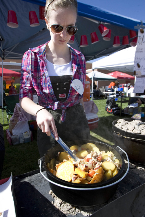 Paul Fraughton  |  The Salt Lake Tribune
Jessica Ryan stirs her "Possum Stew" (chicken and spuds) at Riverview Jr. High School's ninth-grade Dutch oven cook-off.                         
 Friday, May 10, 2013