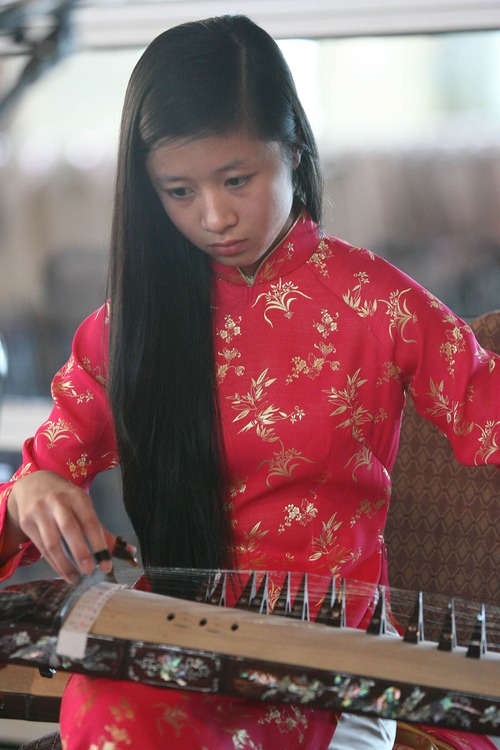 Paul Fraughton  |  The Salt Lake Tribune
Angelina Nguyen plays the Dan Tranh, a traditional pluck zither,  with the Lac Viet Band performing at the Utah Cultural Celebration Center. The center is hosting an exhibit highlighting the art, music and artifacts of Vietnam, as well as a photo exhibit of images from Vietnam by photographer John Steele. Thursday, May 16, 2013